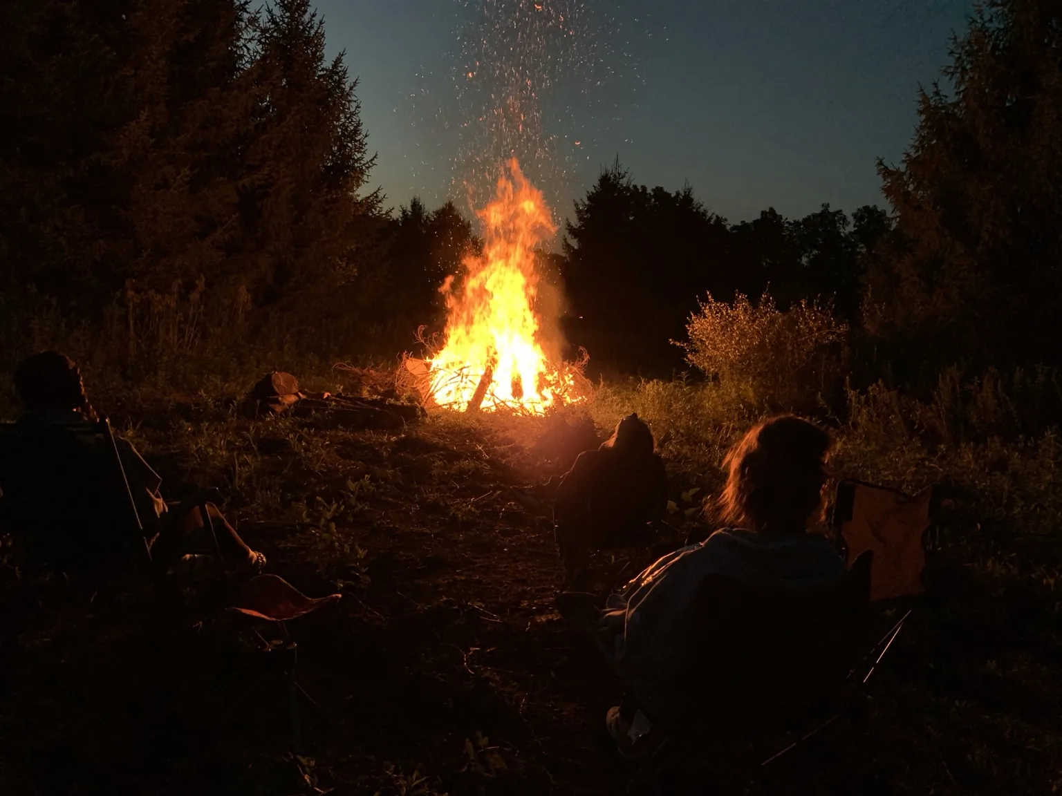 Family and friends gathered around a campfire