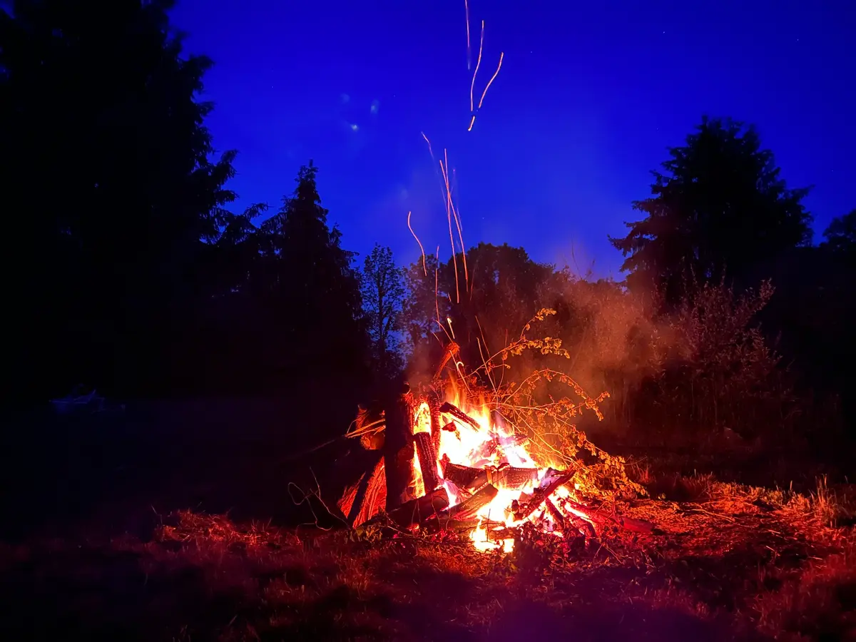 A large campfire burning at night at Halo Hills