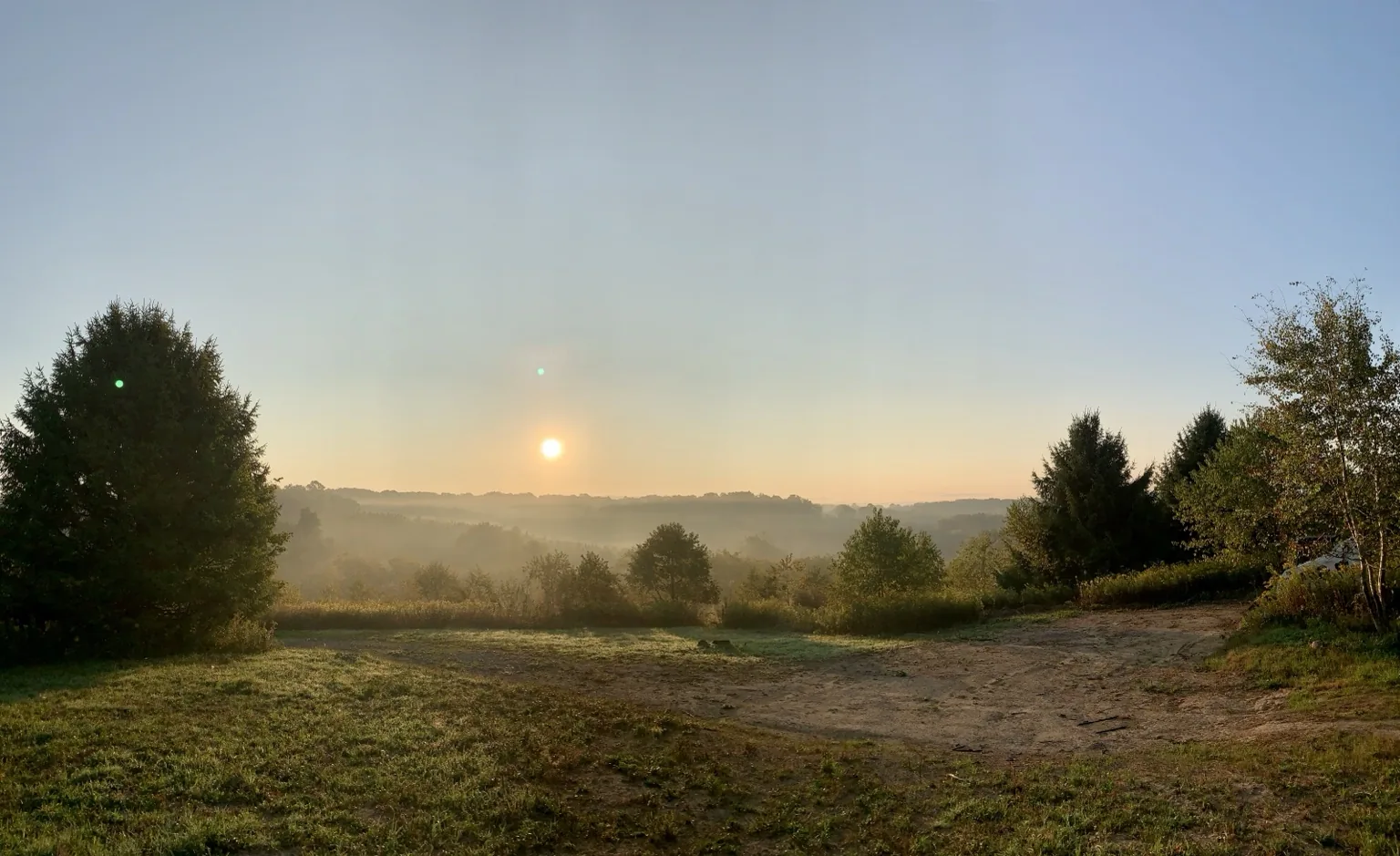 Morning light rising over the wooded hills at Halo Hills