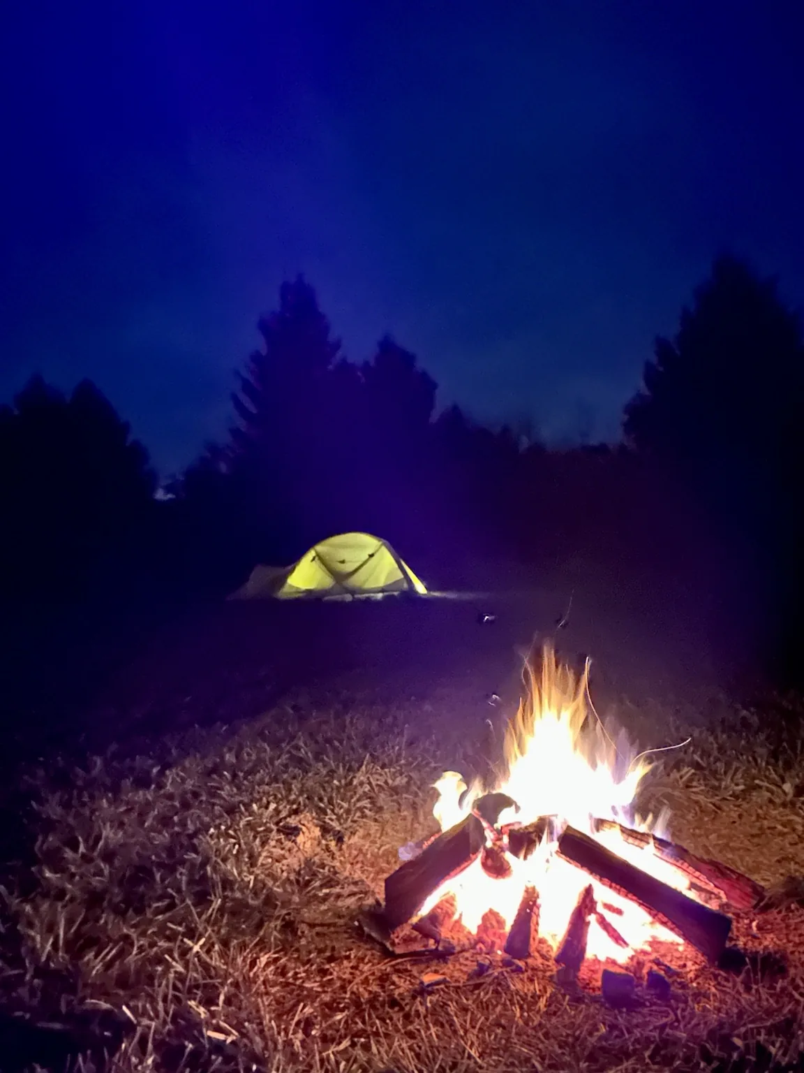 Tent and campfire after sunset